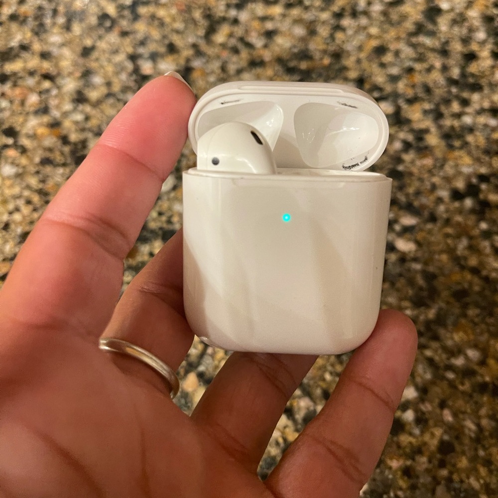 apple airpod charging case and left airpod